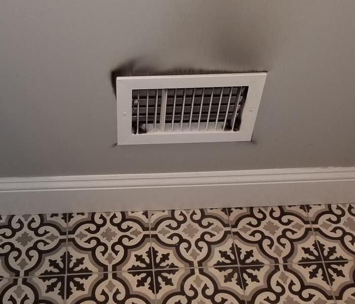 Heating vent with soot damage.