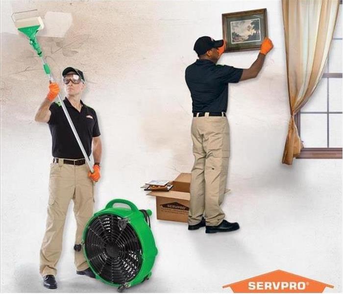 Two SERVPRO Technicians clean fire damage soot.