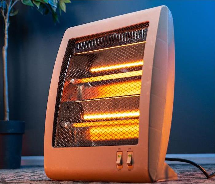  "a small electric heater in a living room” 