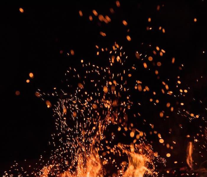 "a close up view of a bright campfire burning at night"